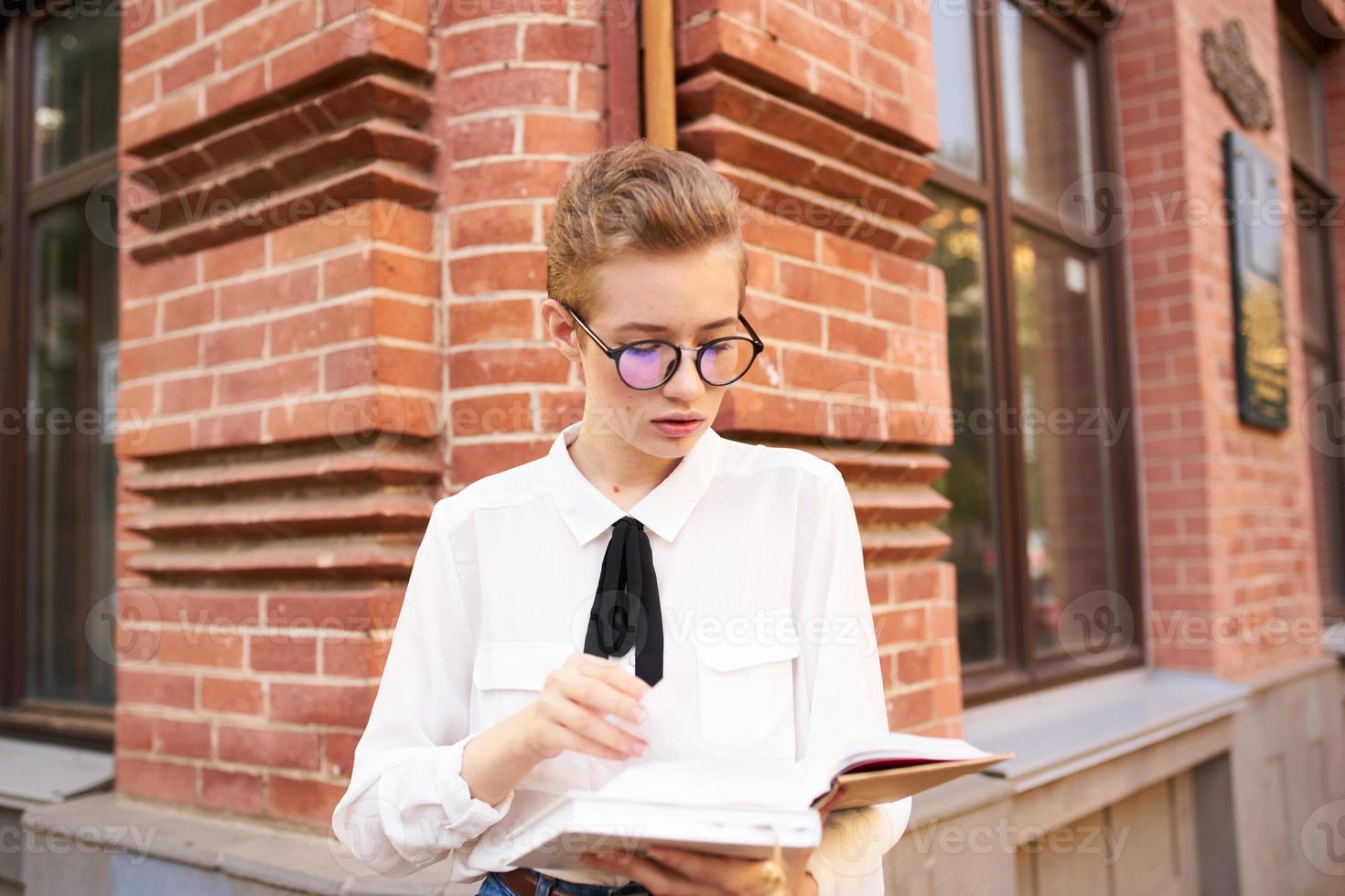 student on the street near the building rest communication photo