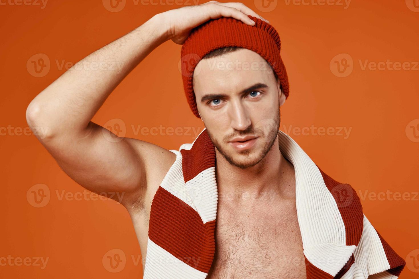 handsome man caps striped sweater studio posing fashion red background photo