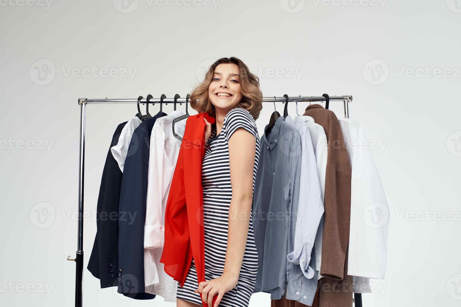 beautiful woman clothes hanger shopping light background photo