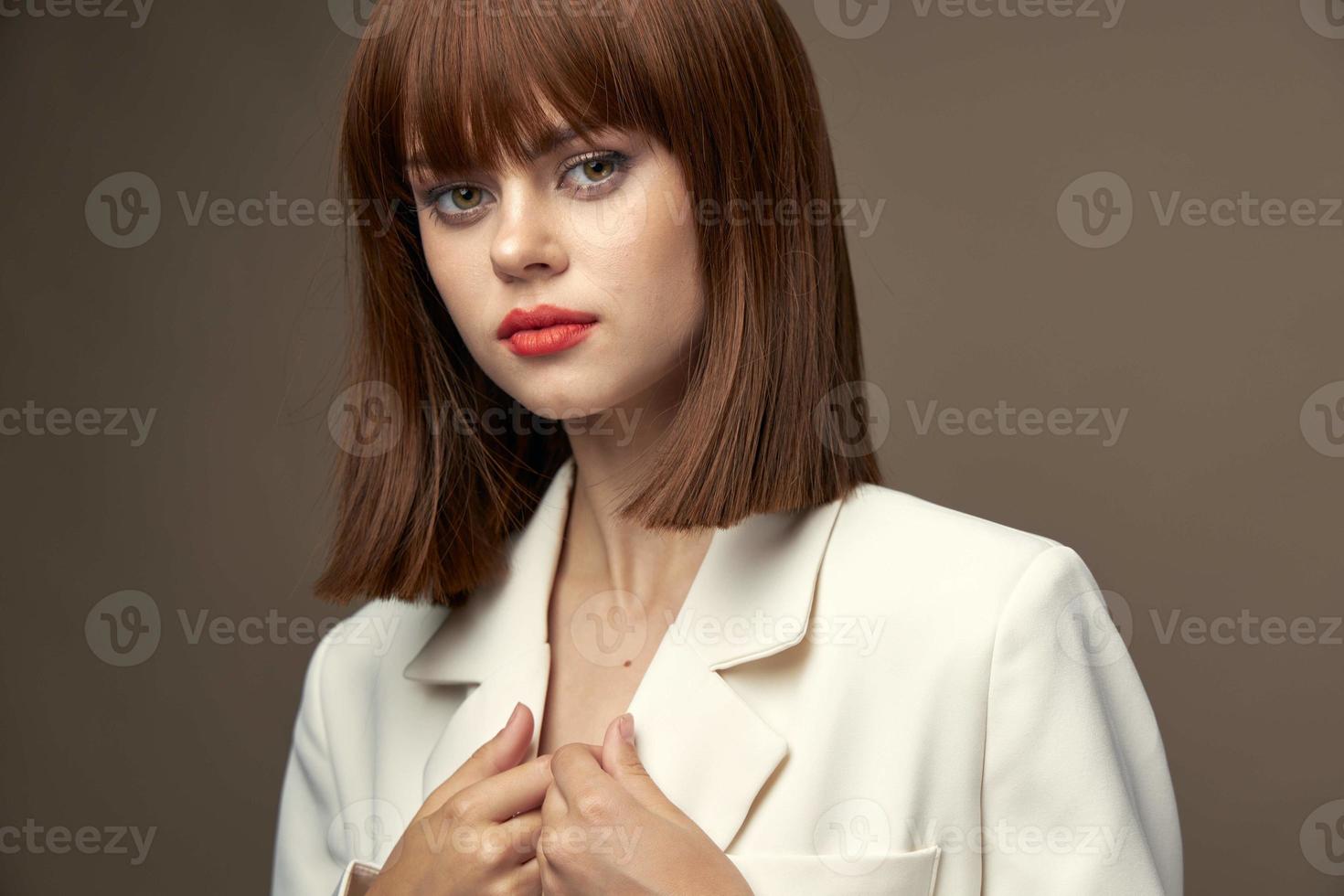 Elegant girl in beige jacket pose for the camera photo