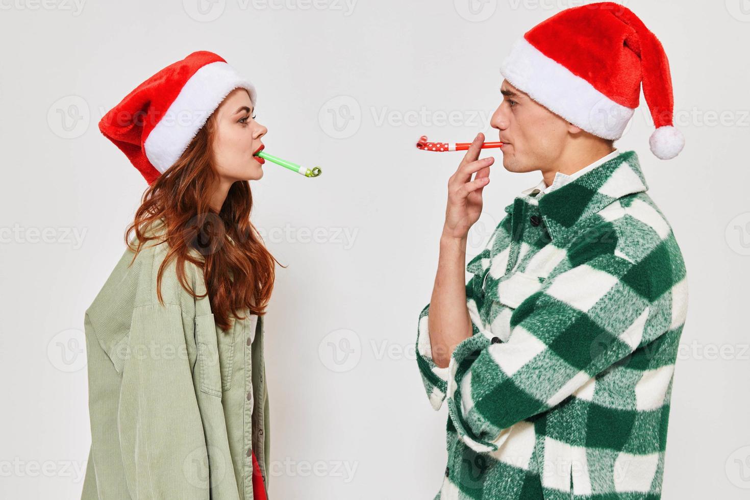 cheerful man and woman in Christmas hats holiday together Friendship photo