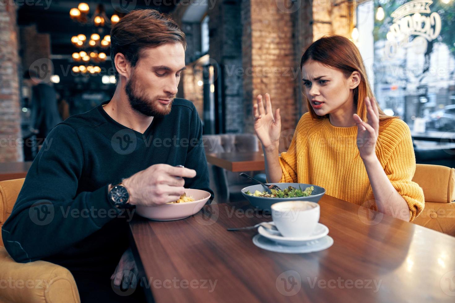 cheerful young couple in a restaurant having a snack rest lifestyle photo