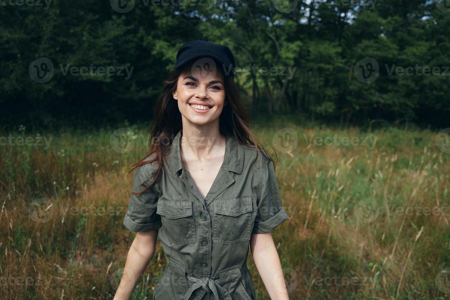 woman in the forest Happy smile green jumpsuit black cap fresh air trees photo