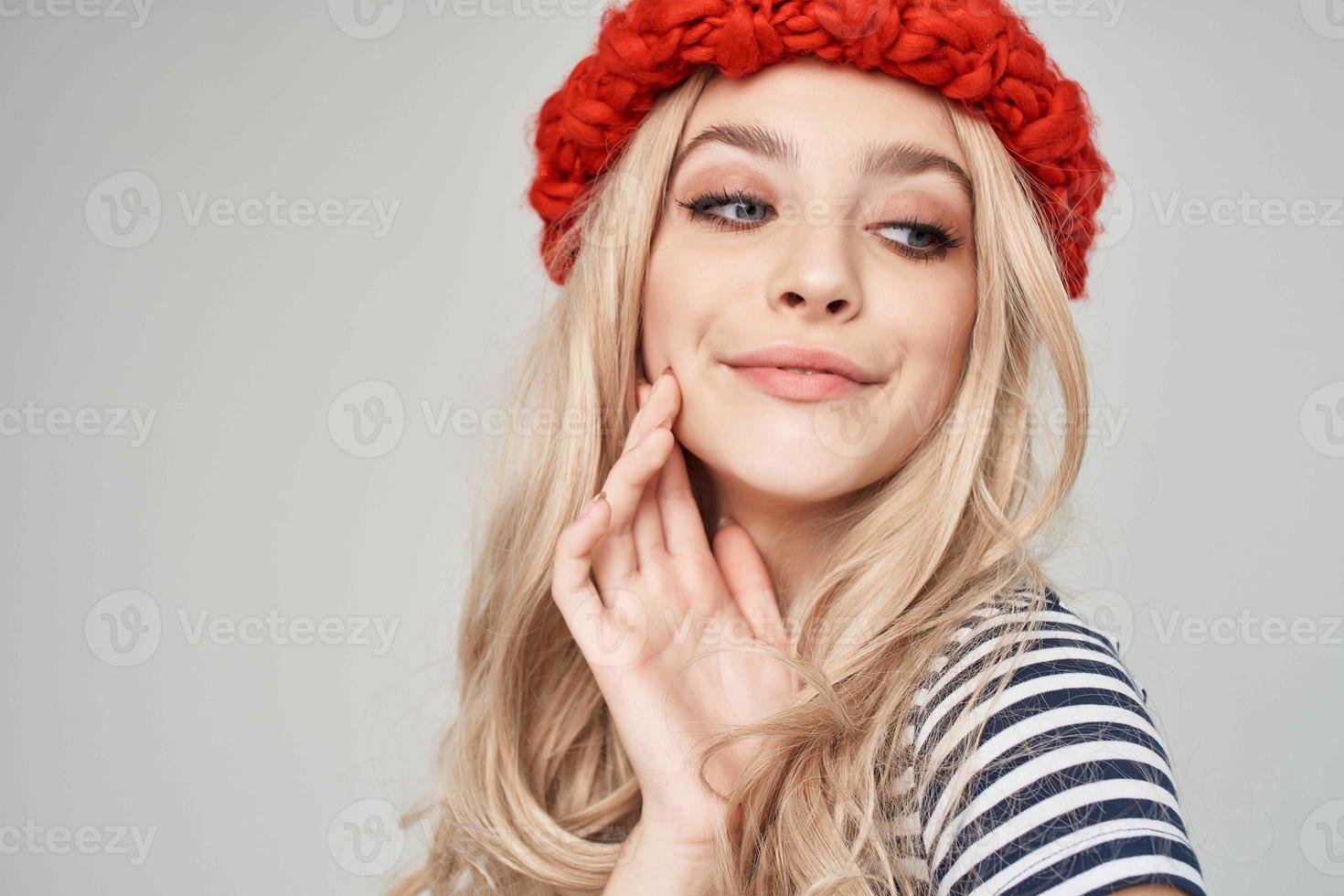 pretty woman in a striped T-shirt Red Hat posing Studio photo