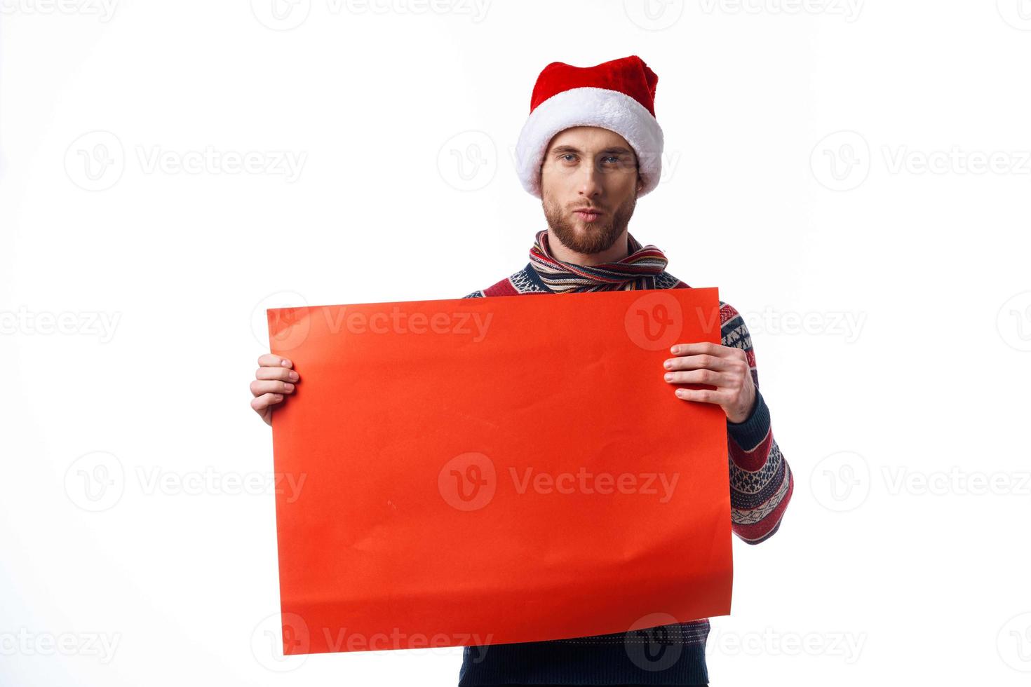 handsome man in New Year's clothes holding a banner holiday light background photo