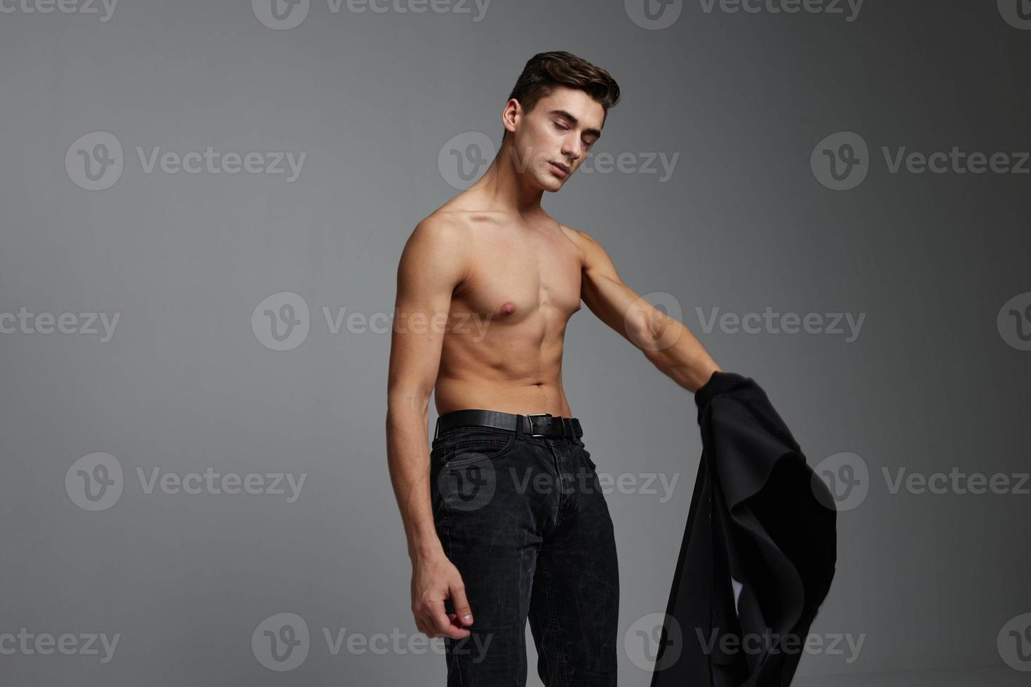 Handsome man nude torso black jacket posing self confidence lifestyle charm photo
