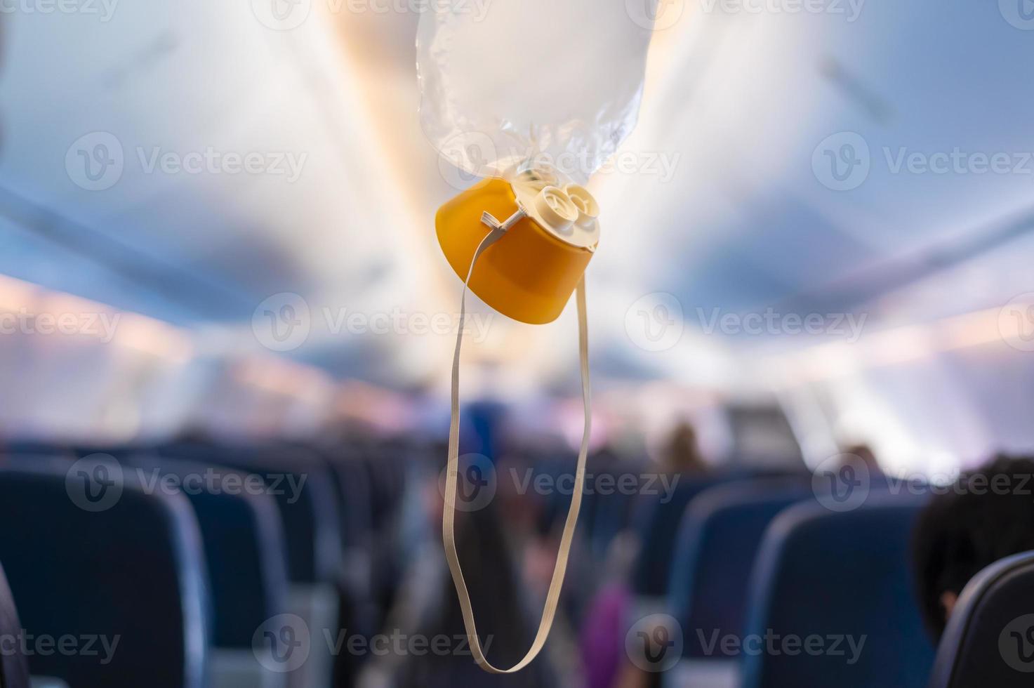 oxygen mask drop from the ceiling compartment on airplane photo