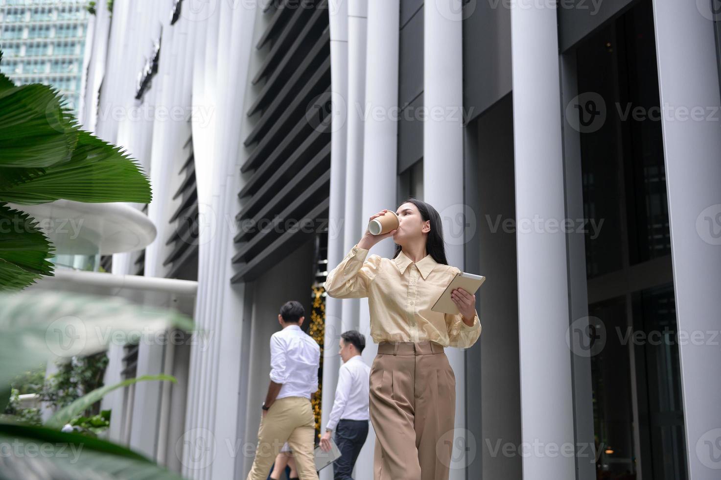 A young businesswoman is working in modern city downtown of Singapore photo