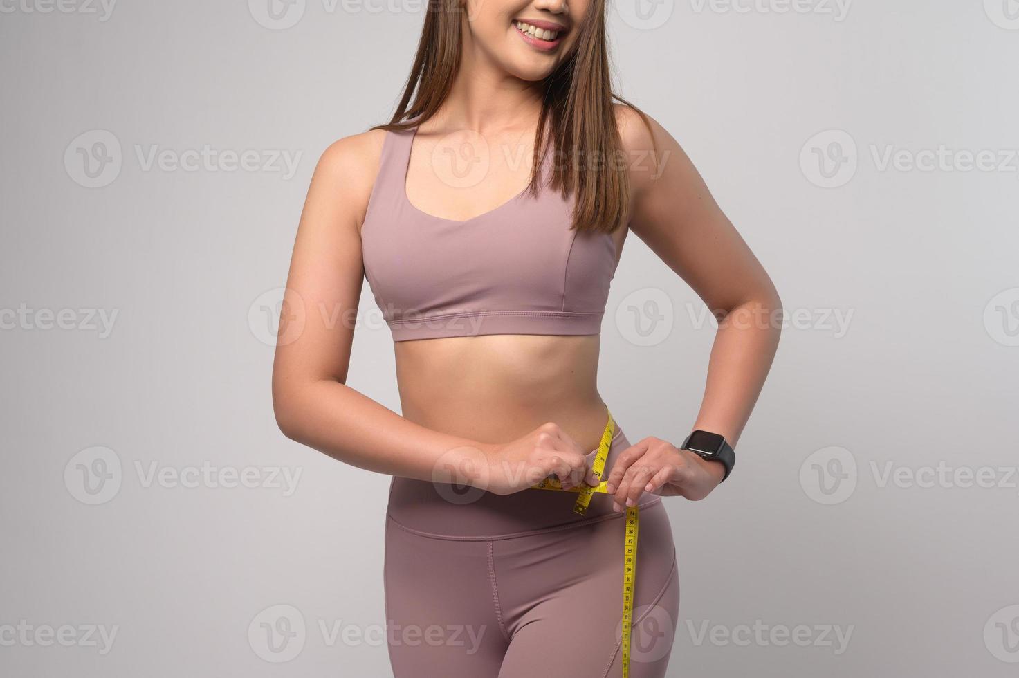 Portrait of asian fitness woman in sport wears over white background studio photo