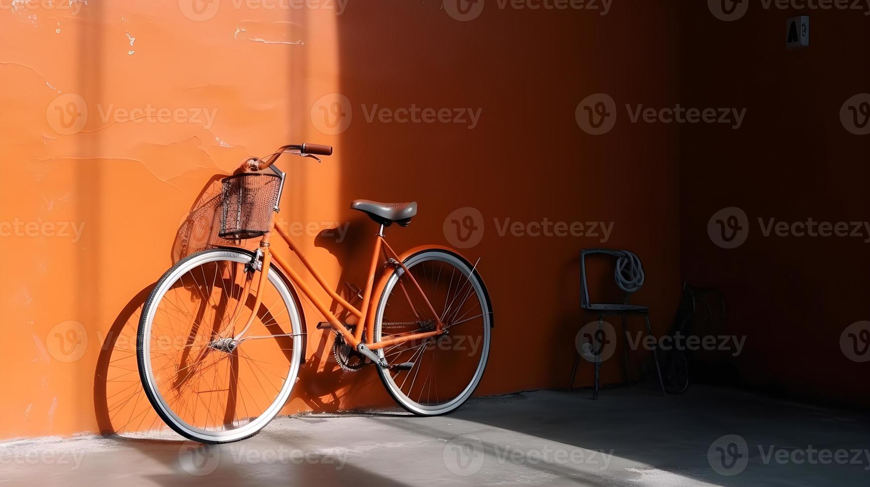Orange City Bike Against Shiny Silver Wall photo