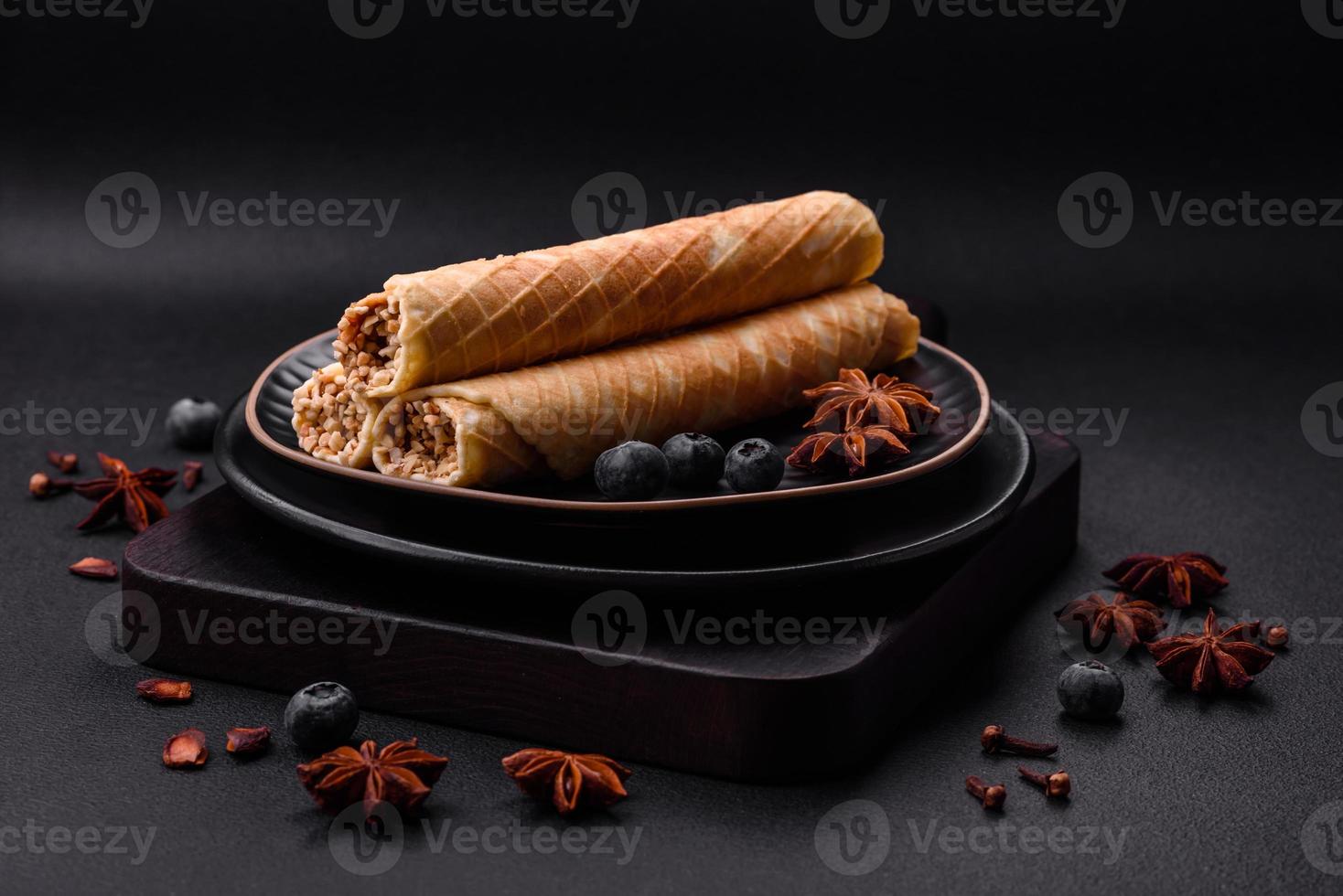 Delicious crispy wafer rolls with cream filling with nuts photo