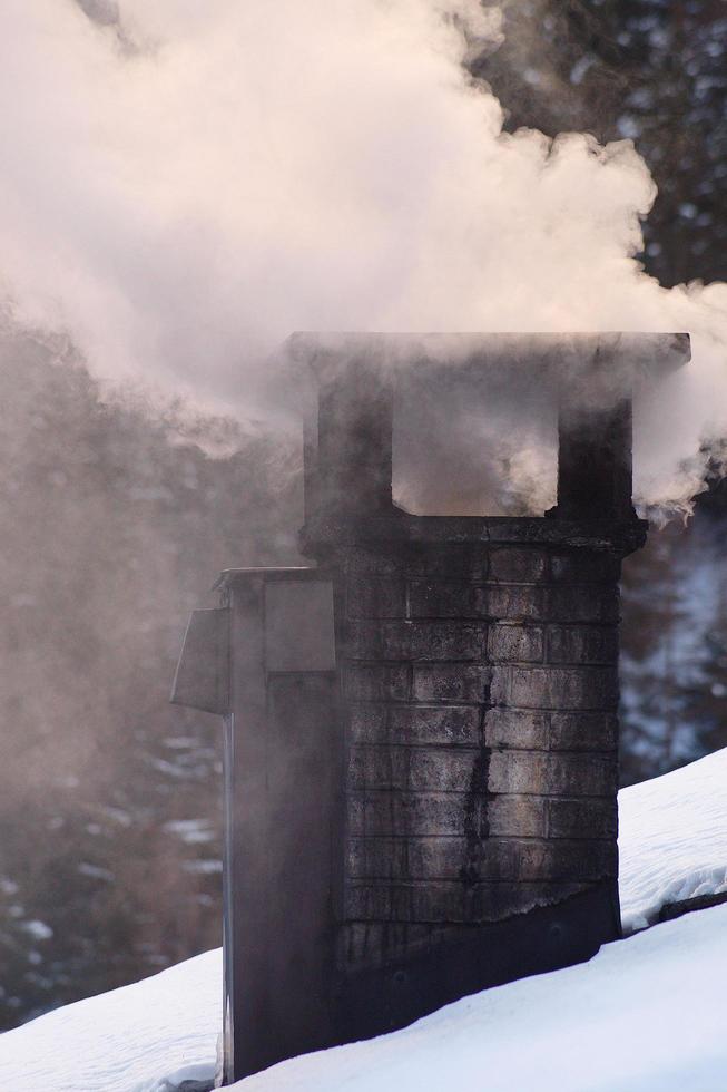 Smoke rises from a chimney photo