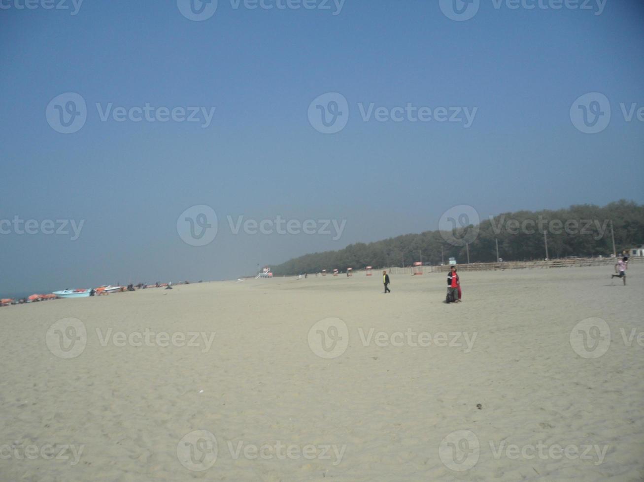 Photo of natural landscape view of a beautiful winter beach and sea on a sunny day in Cox's Bazar, Bangladesh. Travel and Vacation.