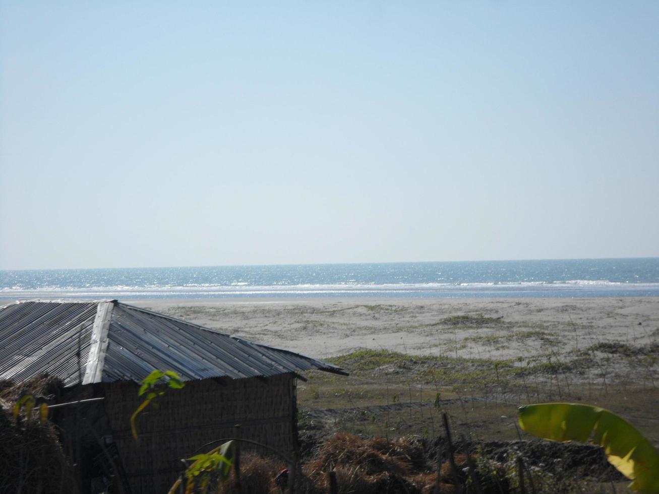 Photo of a sunny day view of a beautiful tropical beach and sea on a sunny day in Cox's Bazar, Bangladesh. Travel and Vacation.