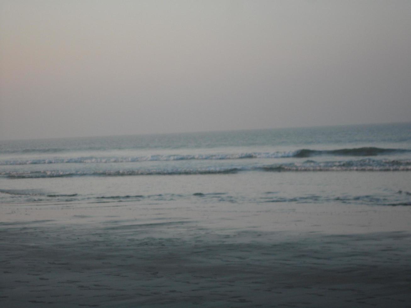 Photo of natural landscape view of beautiful winter beach and sea on a sunny day in Cox's Bazar, Bangladesh. Travel and Vacation.