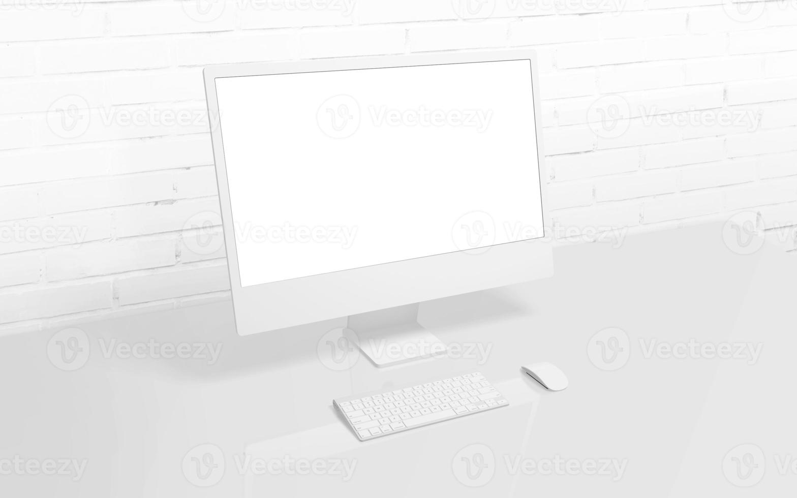White computer display on work desk with brick wall in background. Isolated screen for mockup, app or web page presentation photo