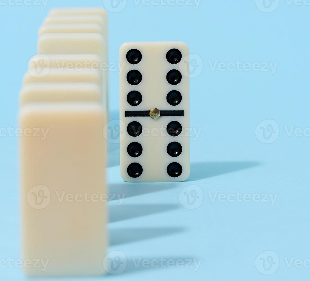 A stack of dominoes on a blue background, an intellectual game photo