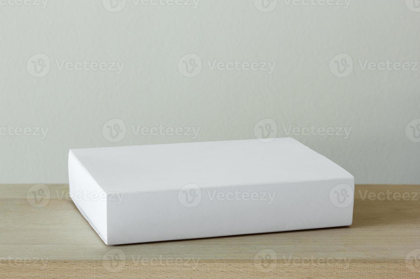 blank white cardboard package box mockup on wooden table photo