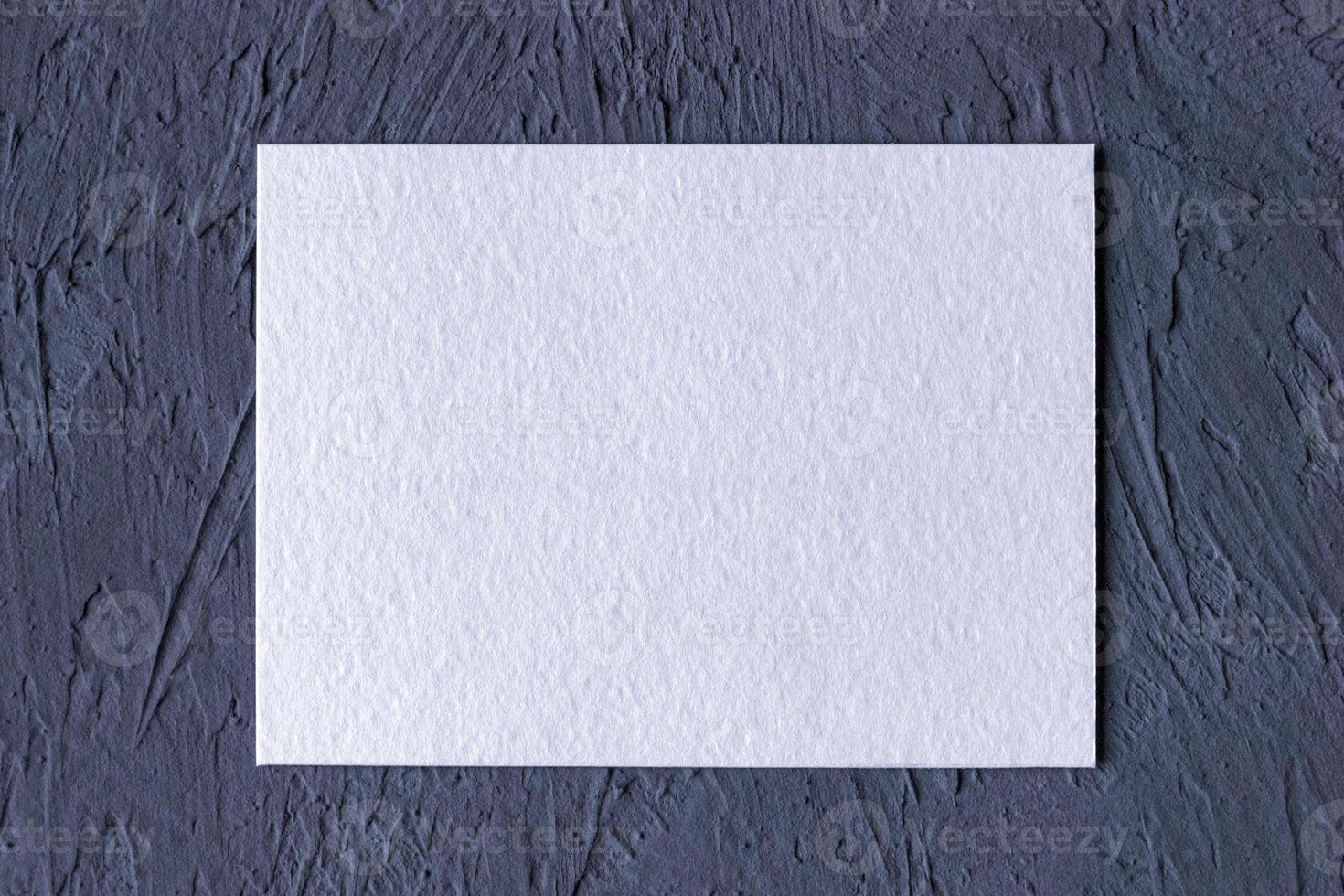 white textured paper card on dark gray solid background photo