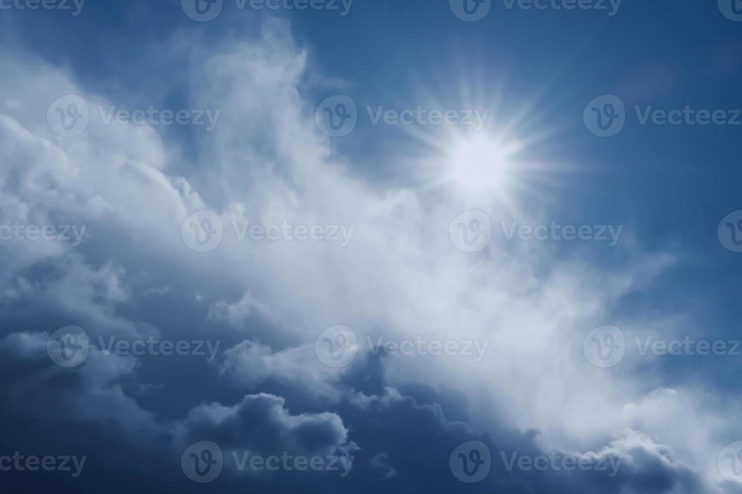 bright natural sun and thunderous dramatic cloud in blue sky photo