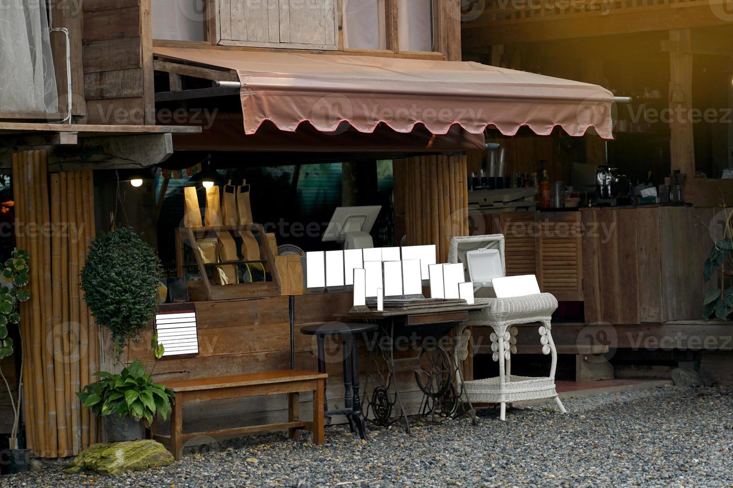 coffee shop fronts the design is vintage style. There is a counter for taking orders, making payments, placing signs to introduce various menus. and give customers a queue with a computer system. photo