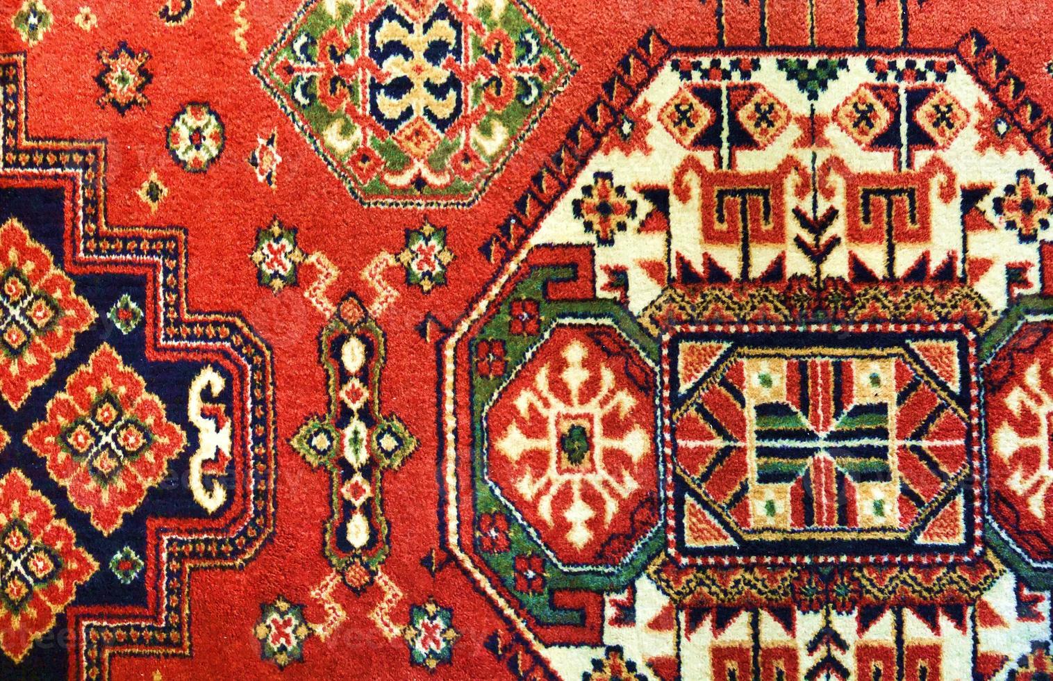 bright red oriental pattern ornament, vintage carpet photo