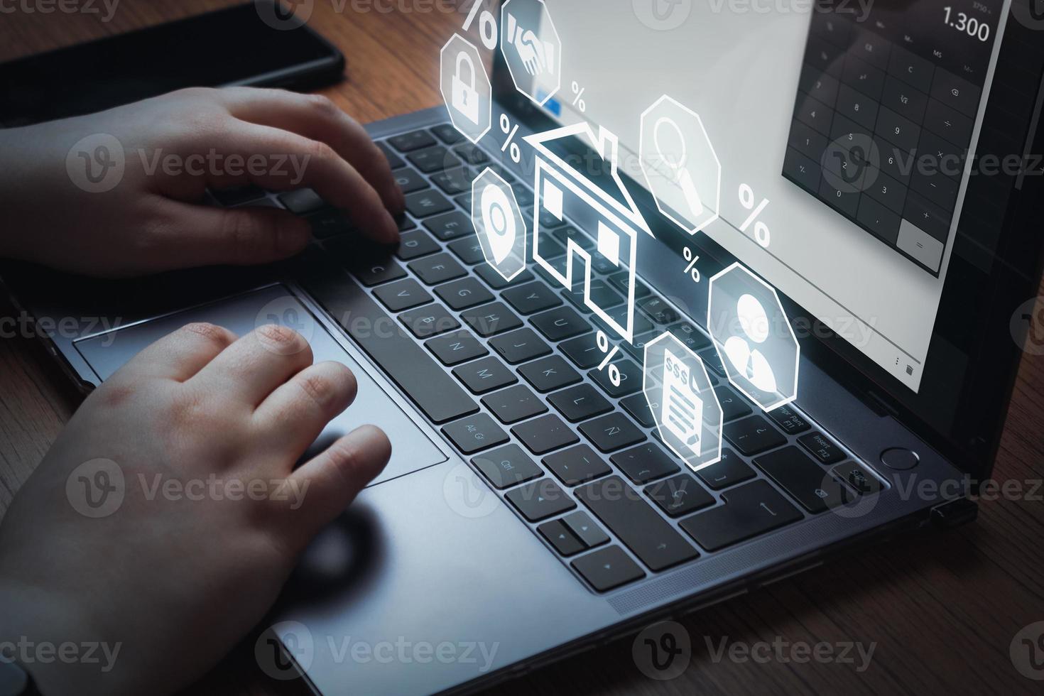 Home mortgage loan concept. Woman using laptop to apply for a Mortgage loan with digital interface. Contract for hire purchase and sale a house. photo