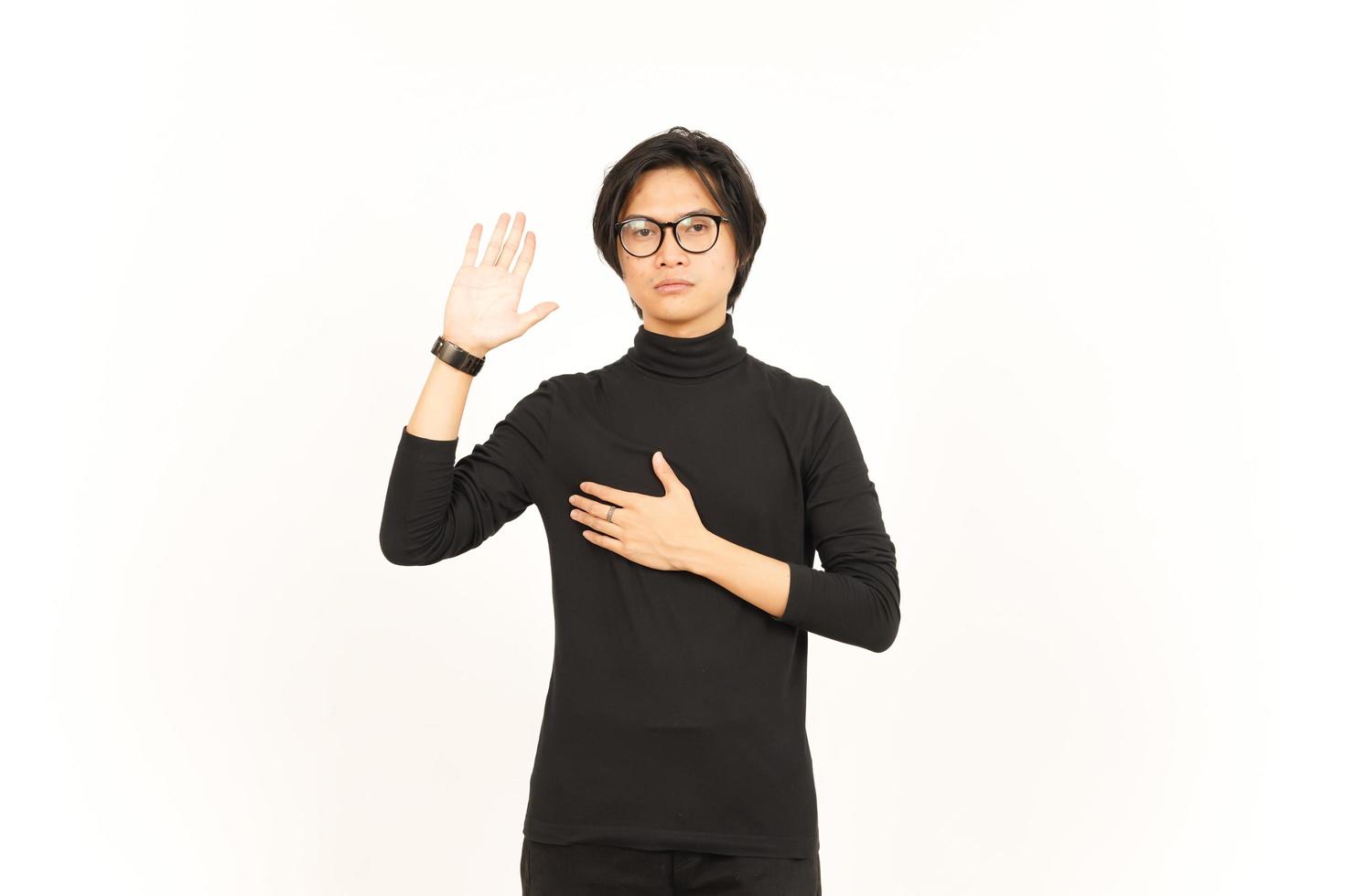Hand on Chest and Doing Swearing Gesture Of Handsome Asian Man Isolated On White Background photo