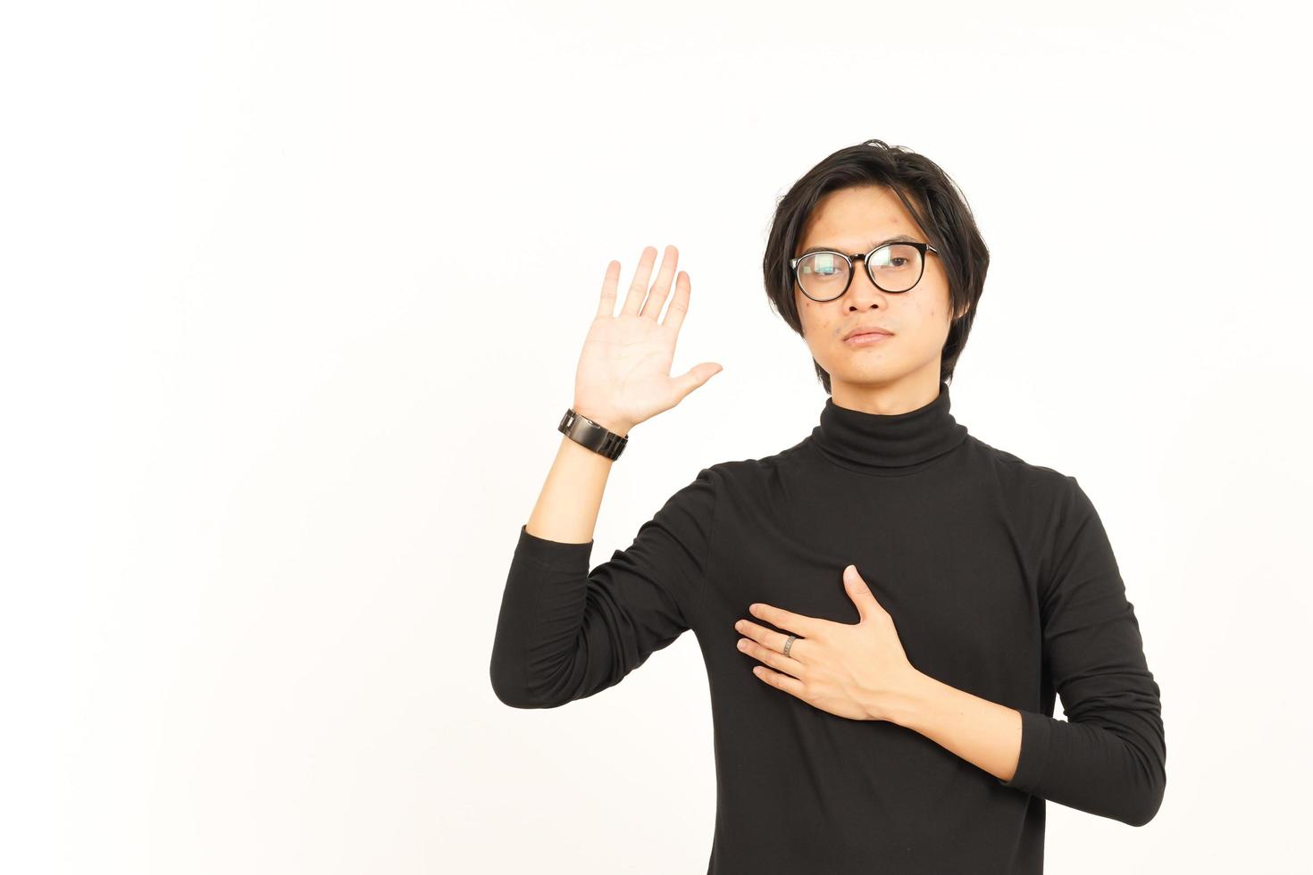 Hand on Chest and Doing Swearing Gesture Of Handsome Asian Man Isolated On White Background photo