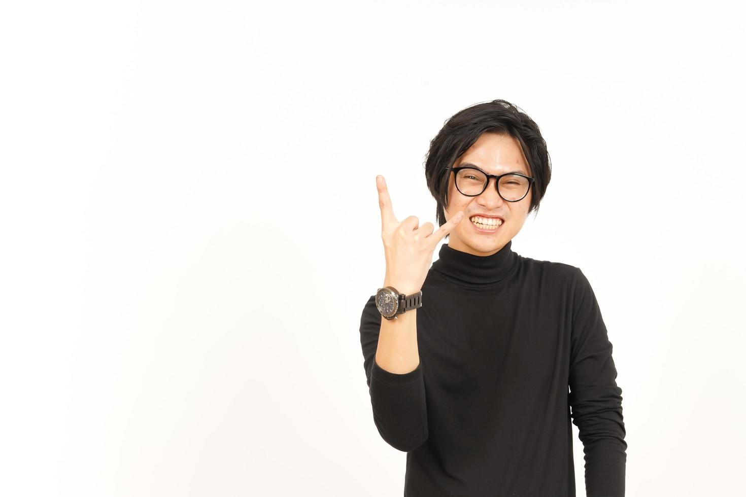 Showing Metal Hand Sign Of Handsome Asian Man Isolated On White Background photo