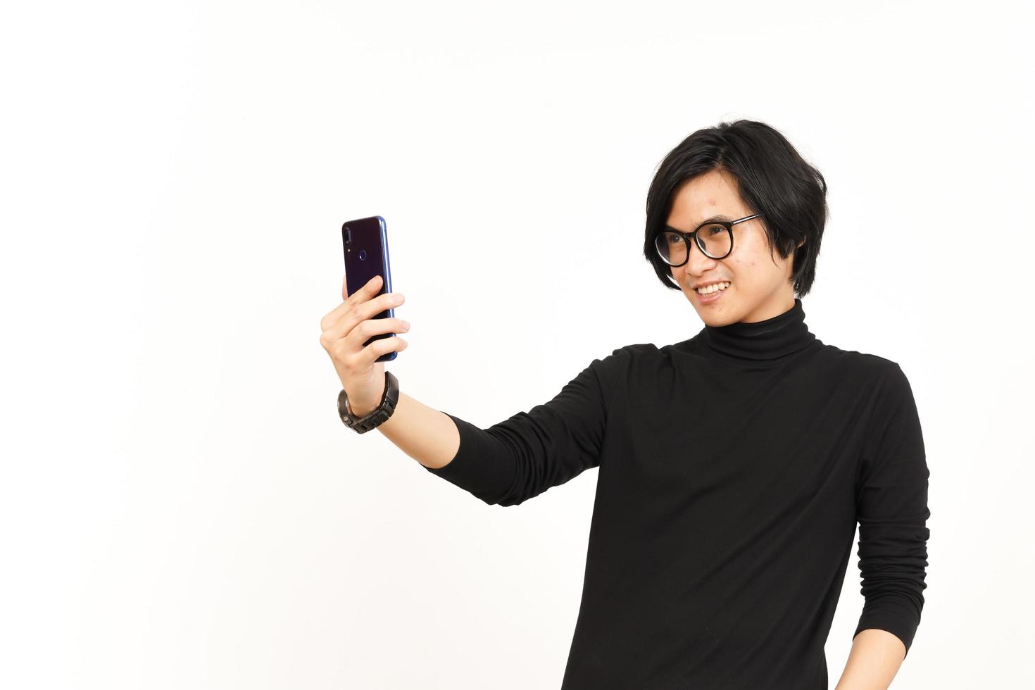 Take a Selfie using Smartphone Of Handsome Asian Man Isolated On White Background photo