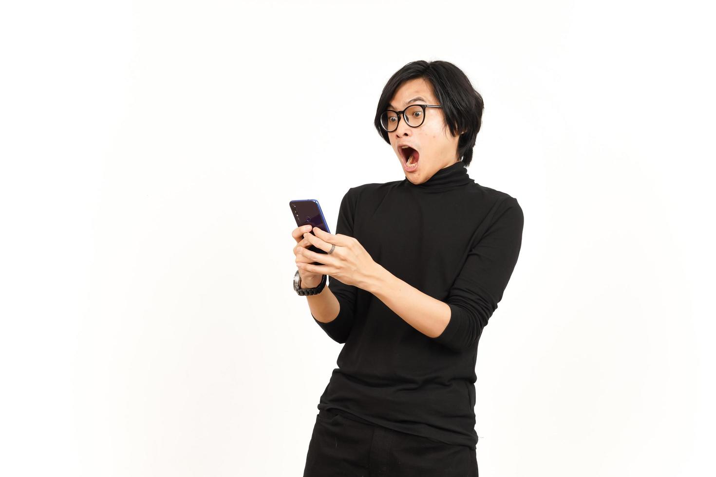 Holding and Using Smartphone With Shocked Face Of Handsome Asian Man Isolated On White Background photo