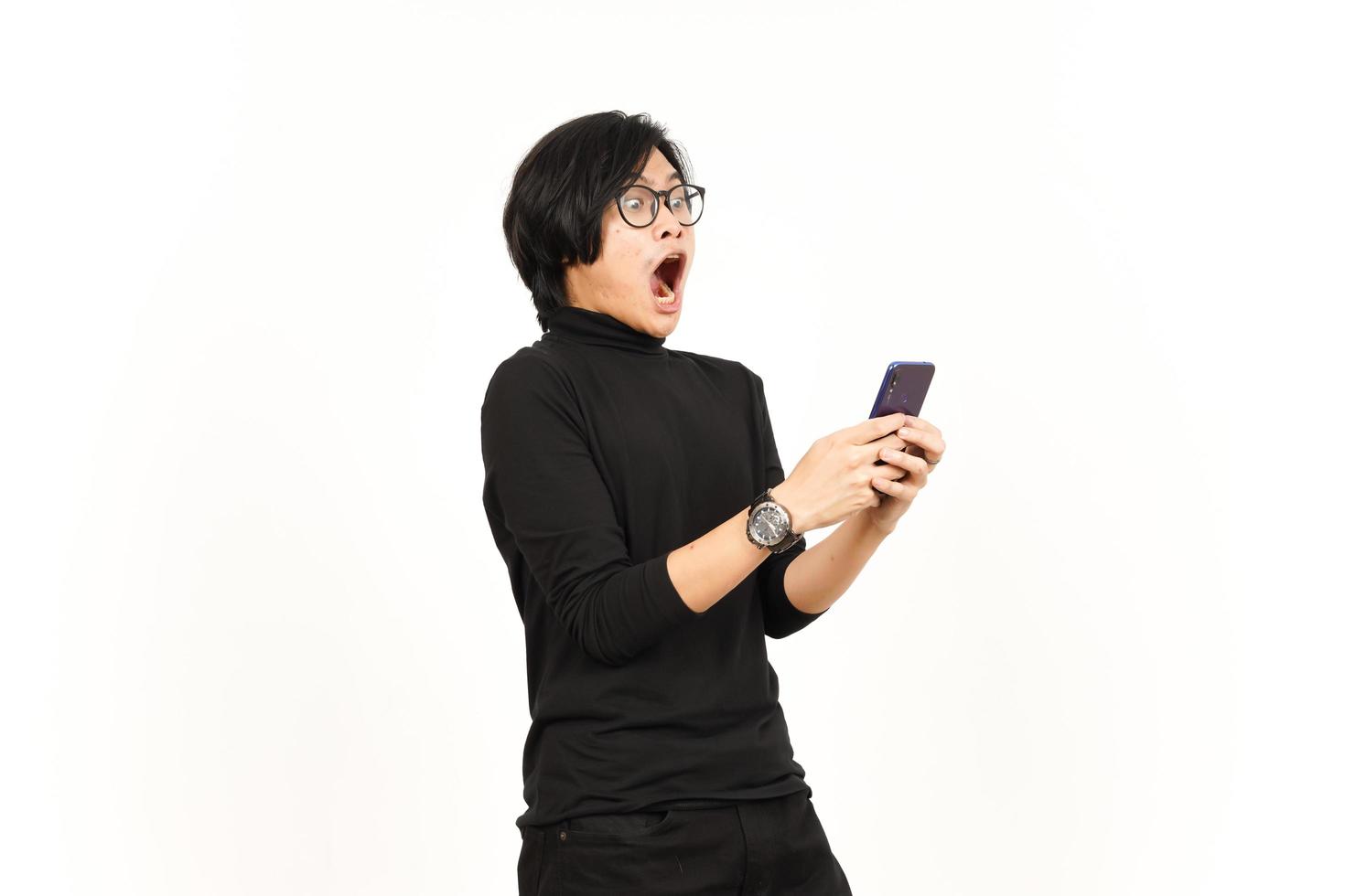 Holding and Using Smartphone With Shocked Face Of Handsome Asian Man Isolated On White Background photo