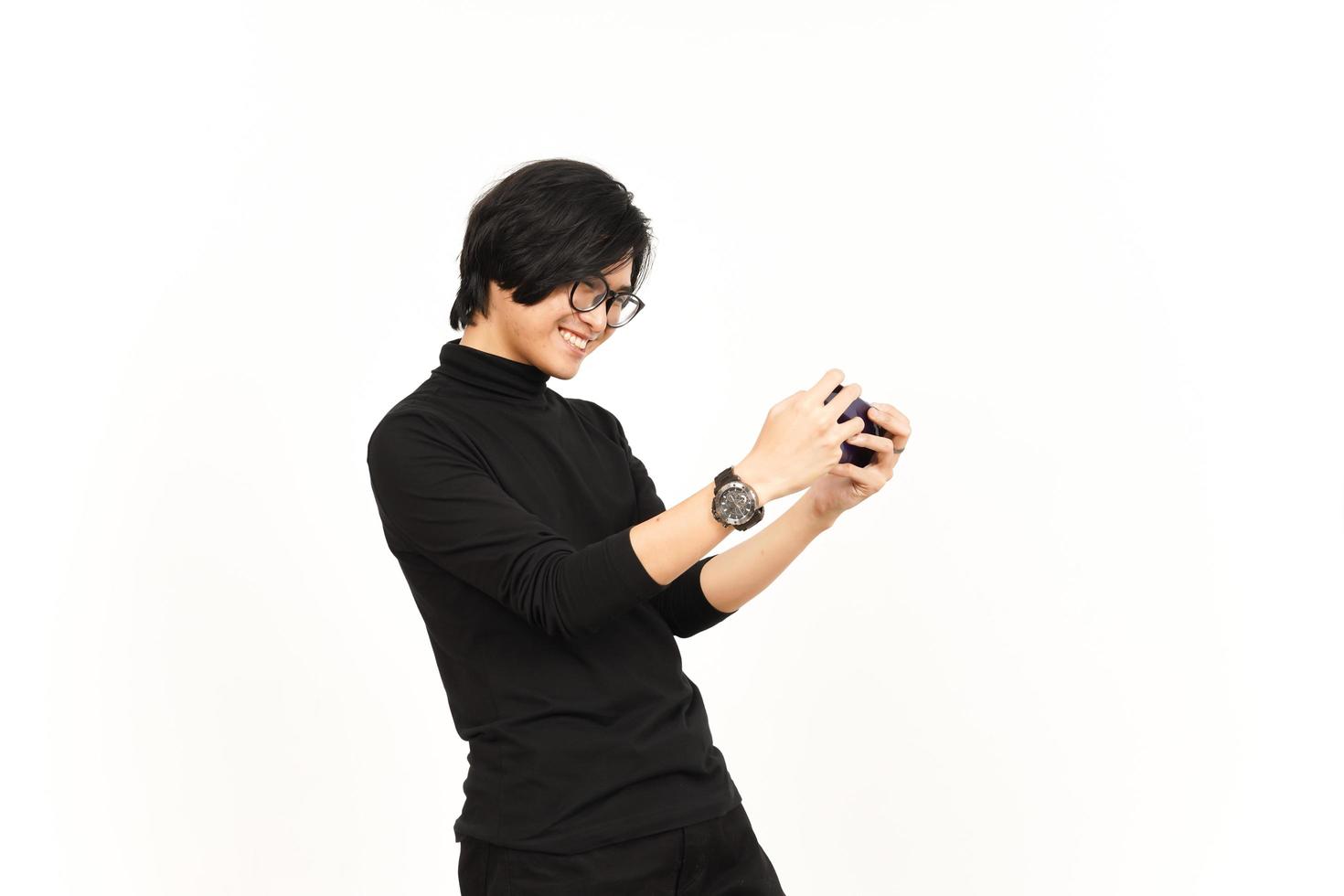 Playing Mobile Game on Smartphone Of Handsome Asian Man Isolated On White Background photo