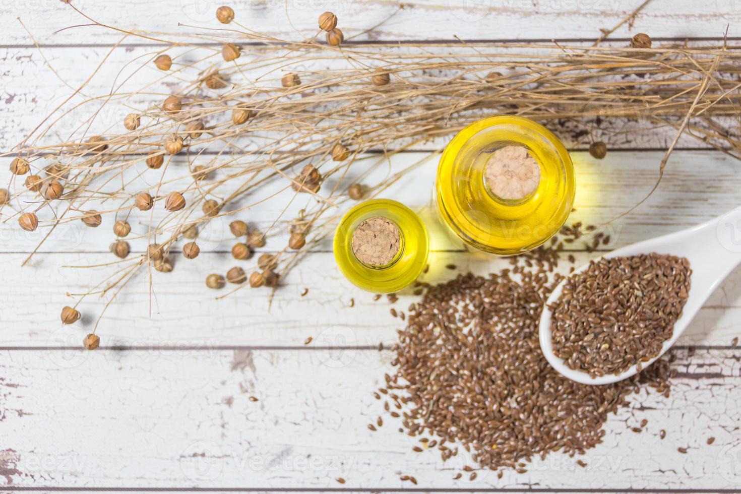 bottles of linseed oil flowers and seeds photo