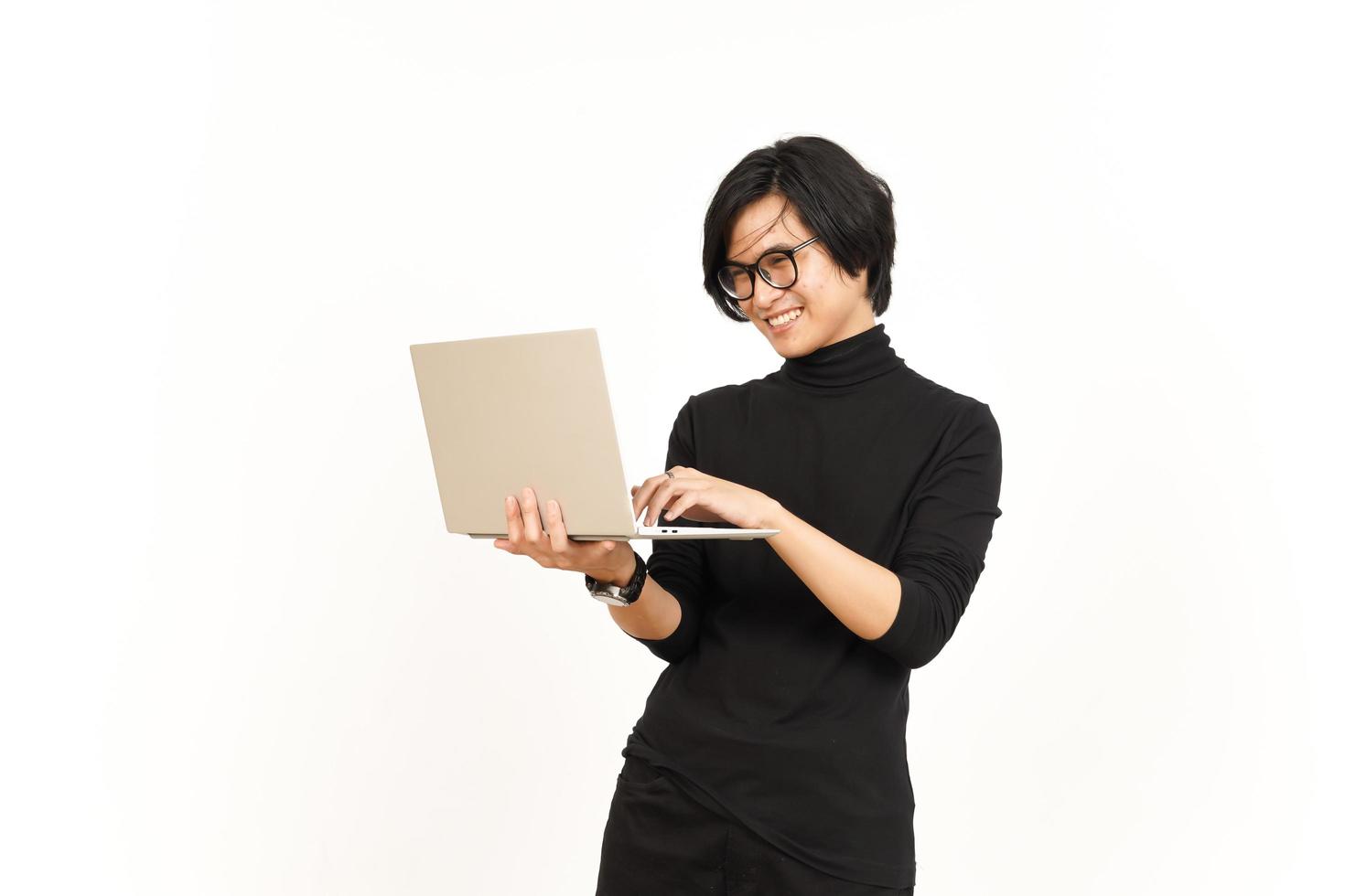 Standing and Using Laptop Of Handsome Asian Man Isolated On White Background photo