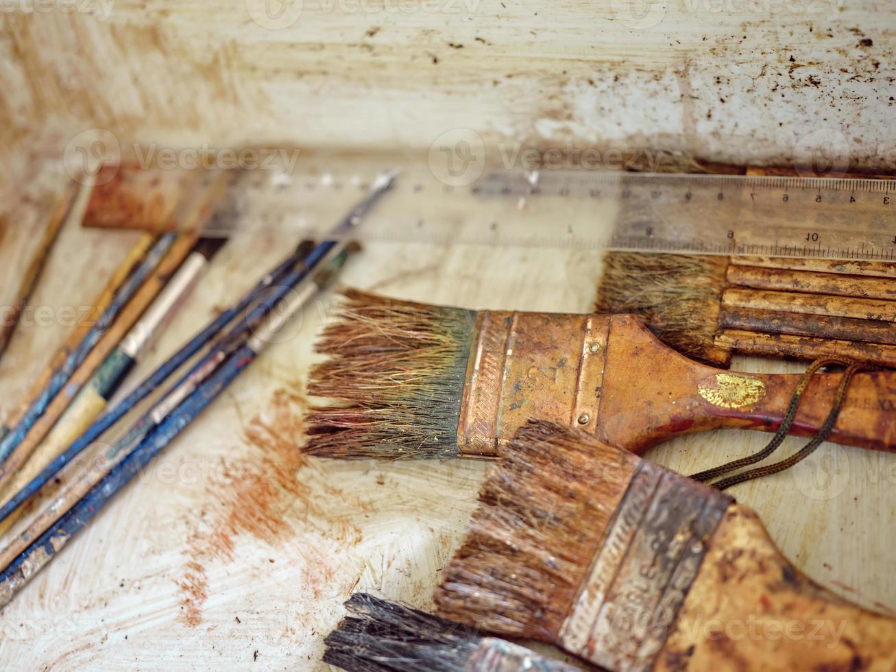 Row of artist paintbrushes closeup on artistic  background . photo