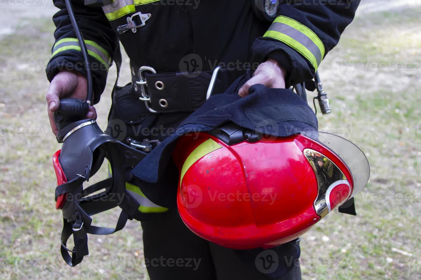 Fireman. Hands of a fireman with a helmet and a mask. photo