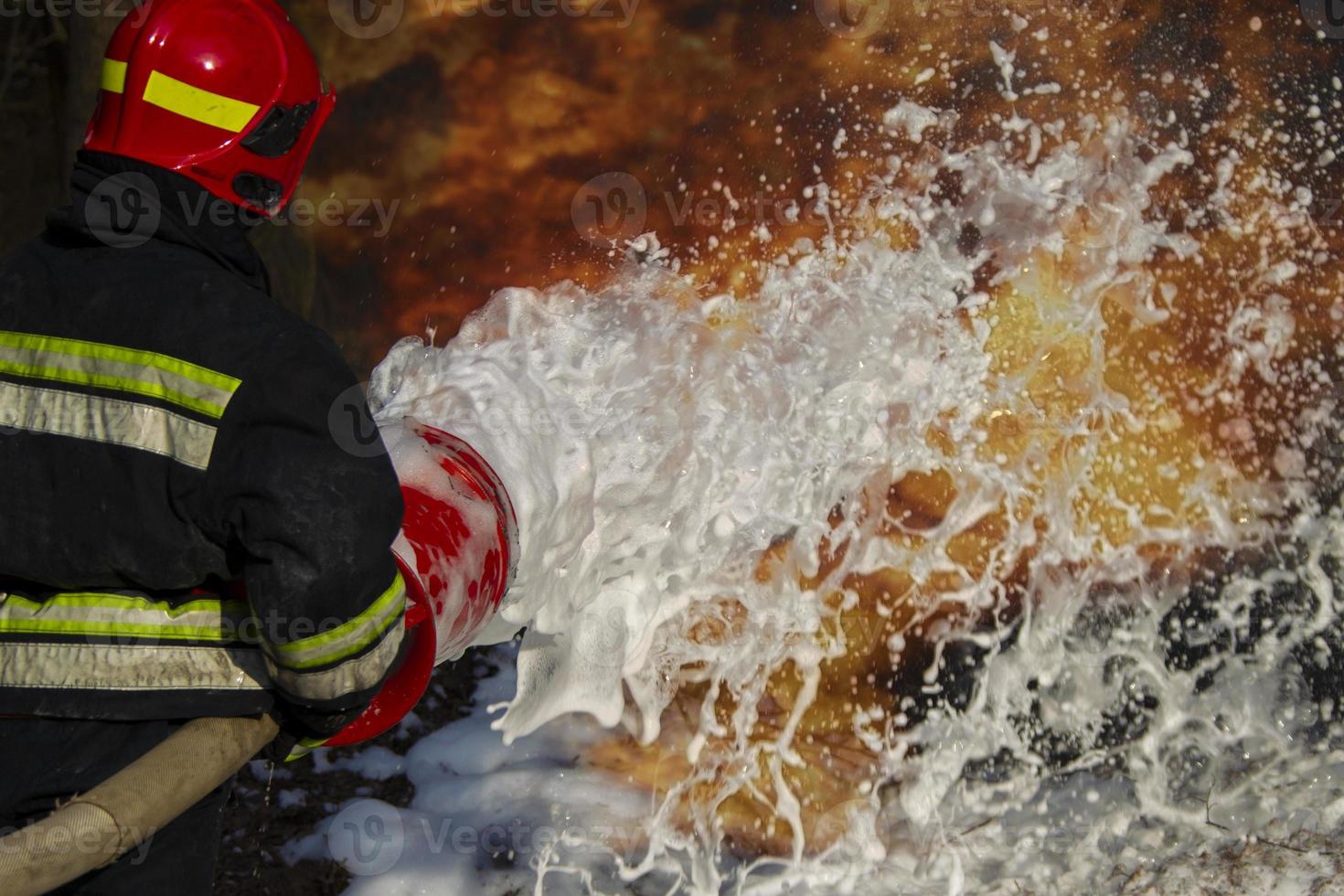 Firefighters extinguish a fire. Fire foam and fire. photo