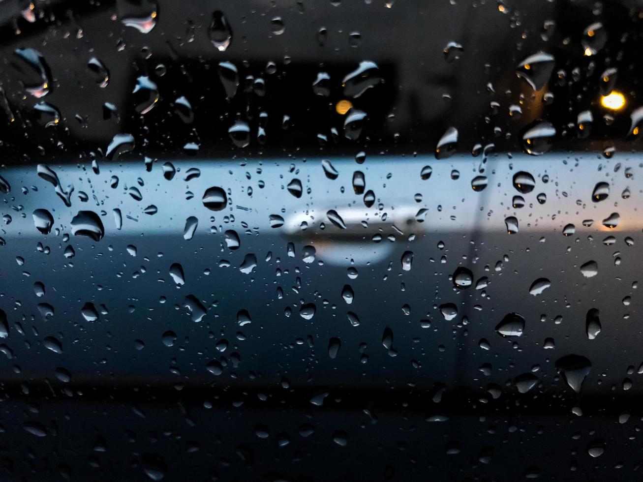 raindrops splashing on the car window photo