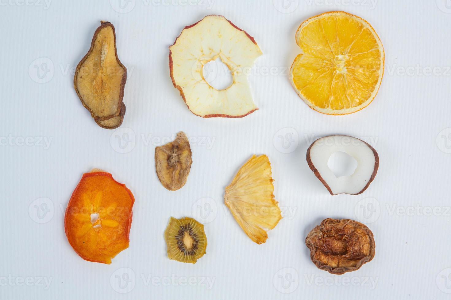 Dried fruits isolated on white background. Healthy eating concept. Top view. Healthy vegetarian food concept. Dried fruit chips. photo