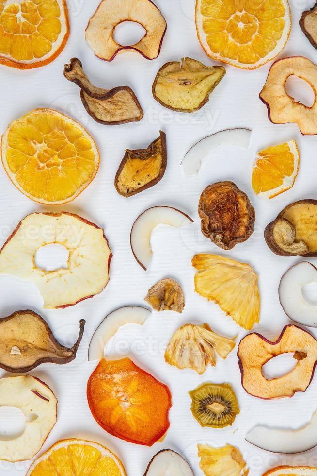 Dried fruits isolated on white background. Healthy eating concept. Top view. Healthy vegetarian food concept. Dried fruit chips. photo