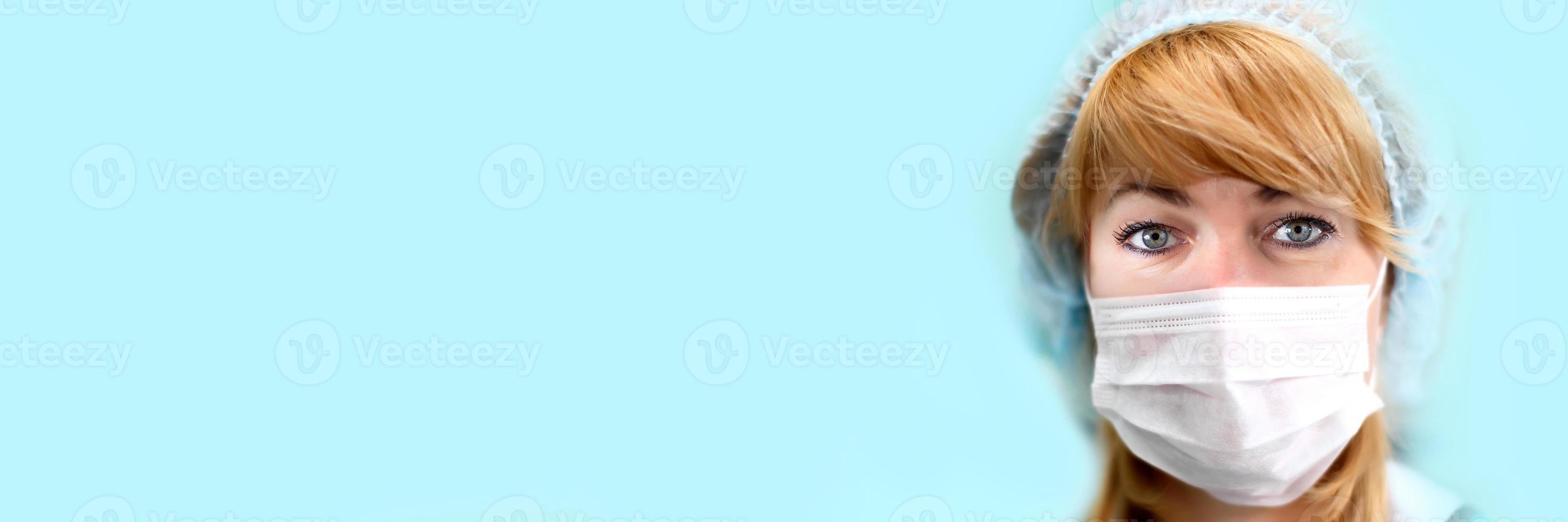 Face of a doctor in a mask and hat.Image of a trainee doctor looking at the camera. photo