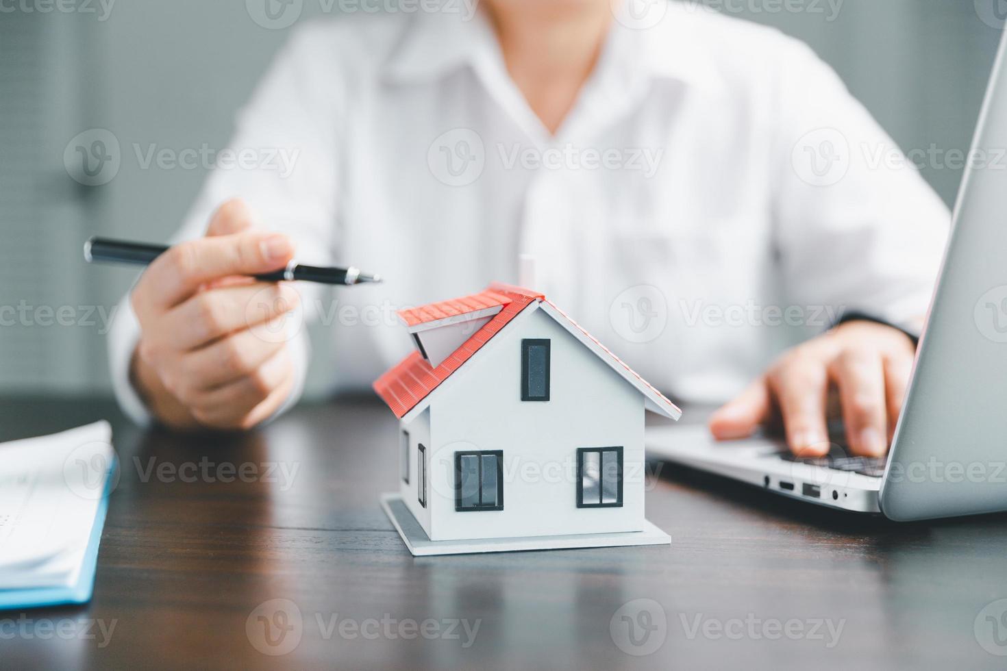 Real estate agents offer contracts to purchase or rent residential. Business person hands with home model, small building red house. Mortgage property insurance moving home and real estate concept. photo