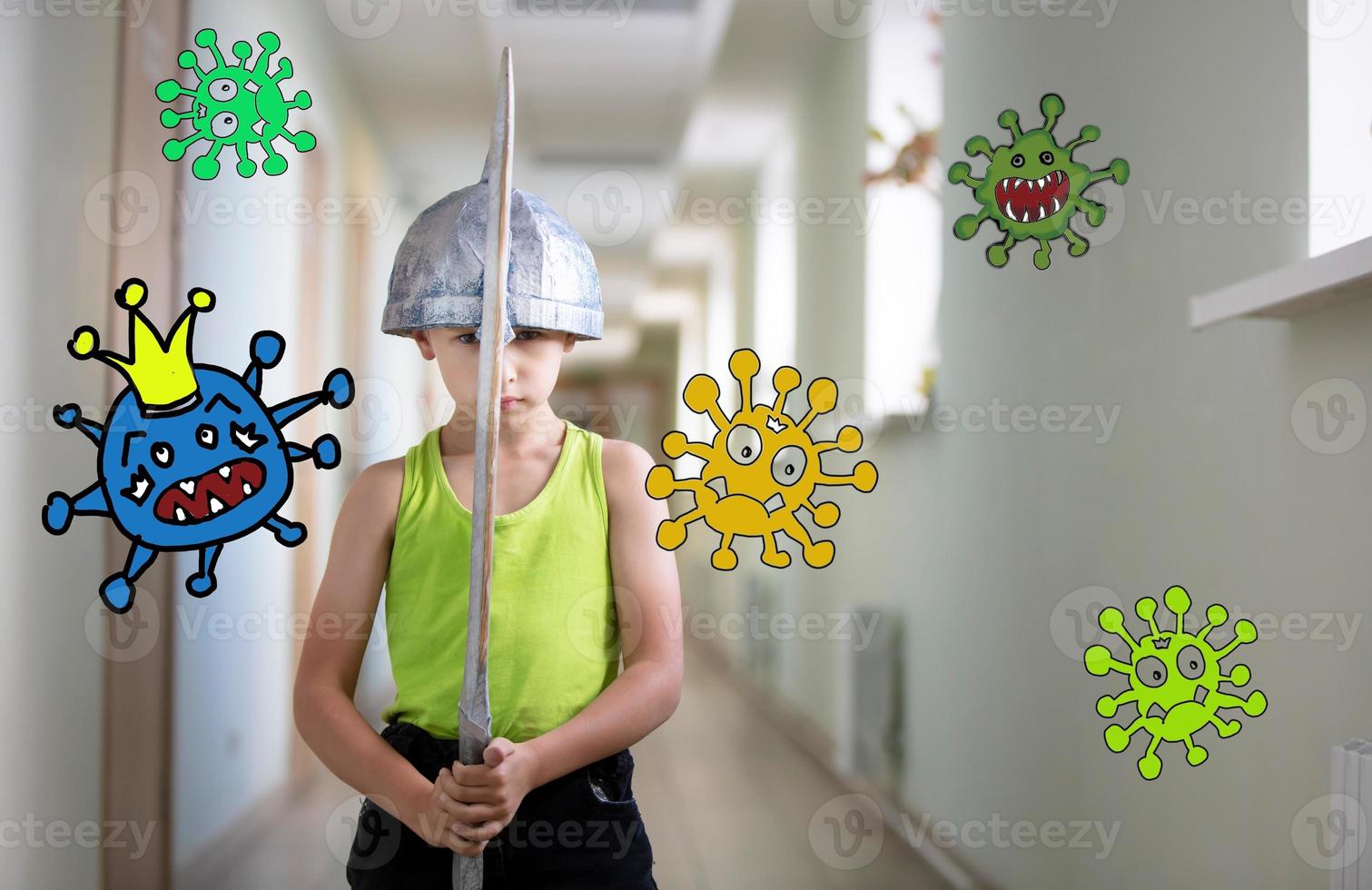 A little boy stays at home with a sword to protect against the coronavirus covid-19 virus. Fight the coronavirus epidemic.  A child is fighting a caricature of a virus. photo