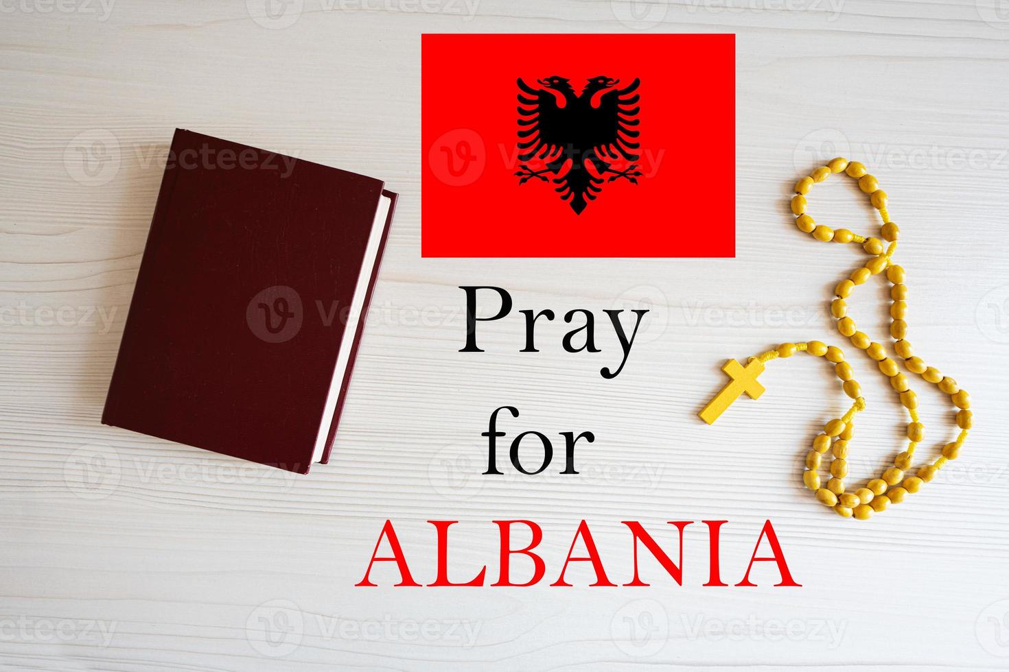 Pray for Albania. Rosary and Holy Bible background. photo