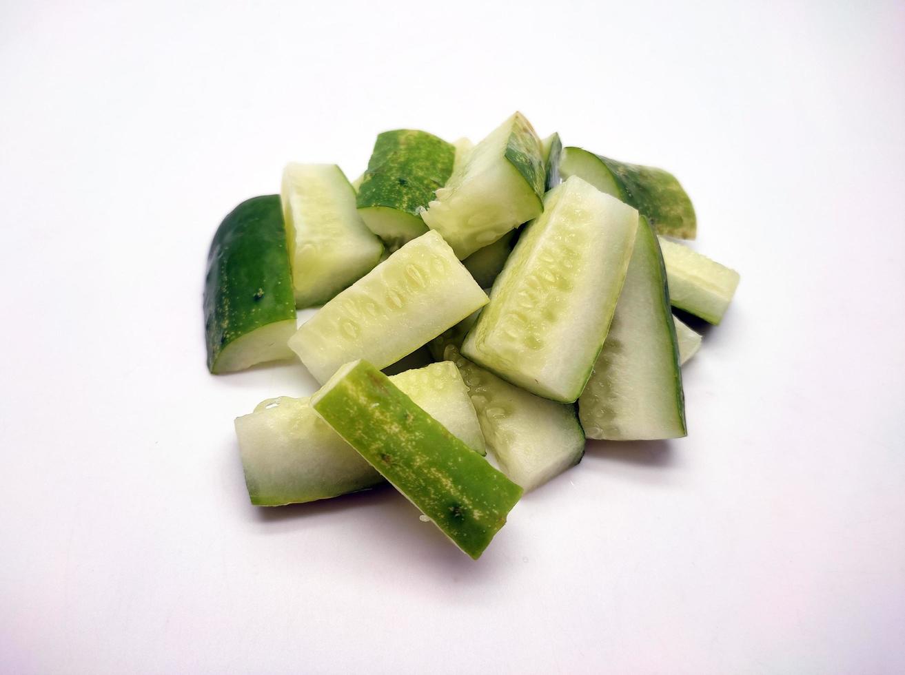 Cubed cucumber slices isolated in white background photo