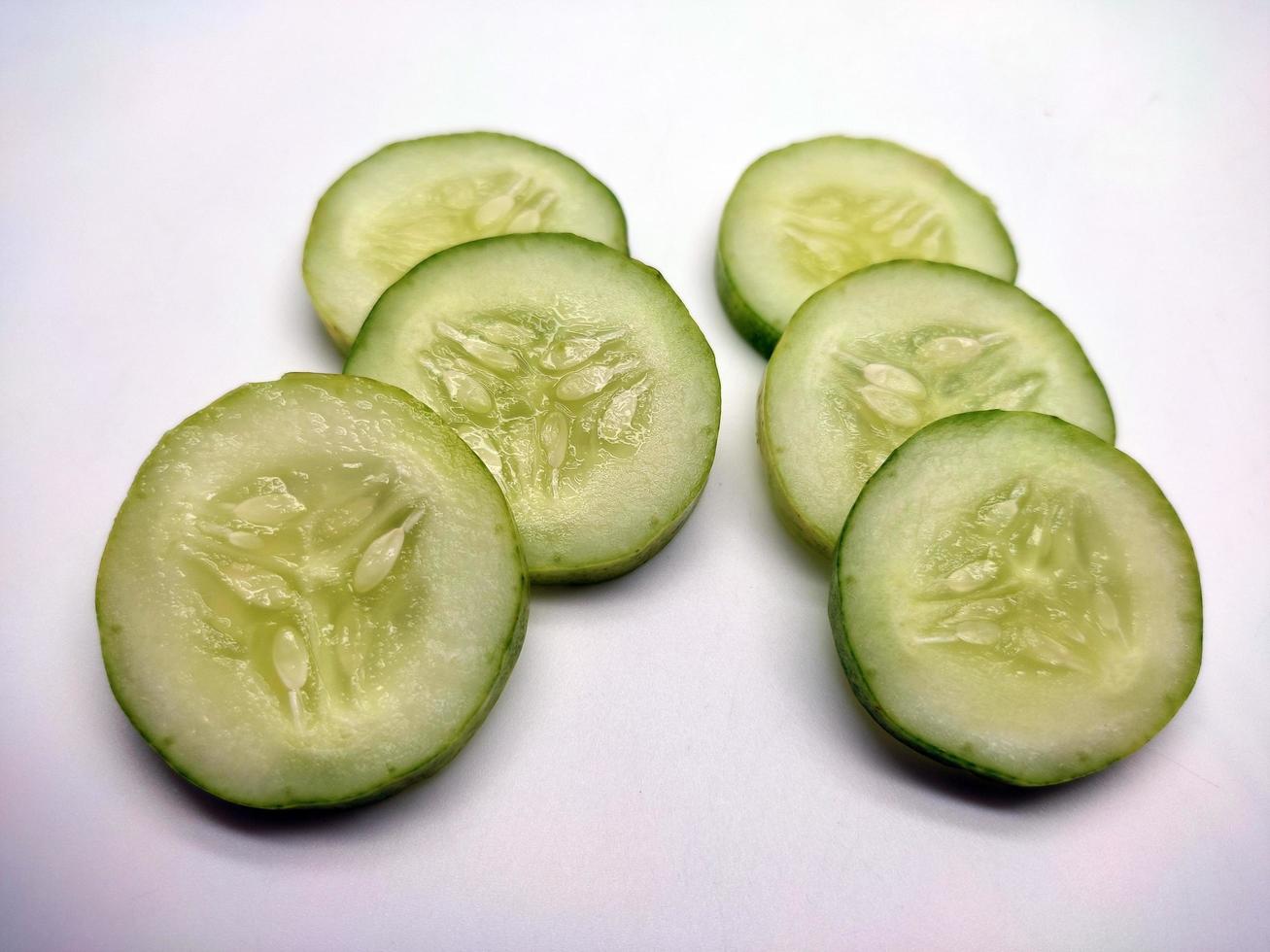 Slices of cucumbers isolated in white background photo