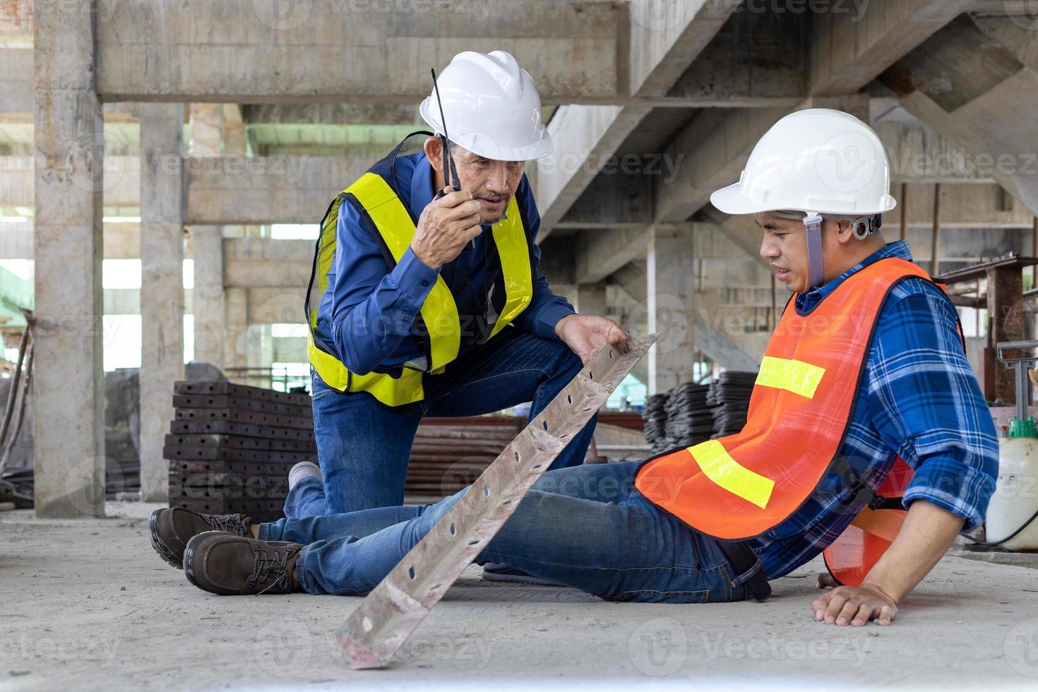Asian factory worker having accident while working in manufacturing site while his colleague is helping  for safety workplace and emergency concept photo