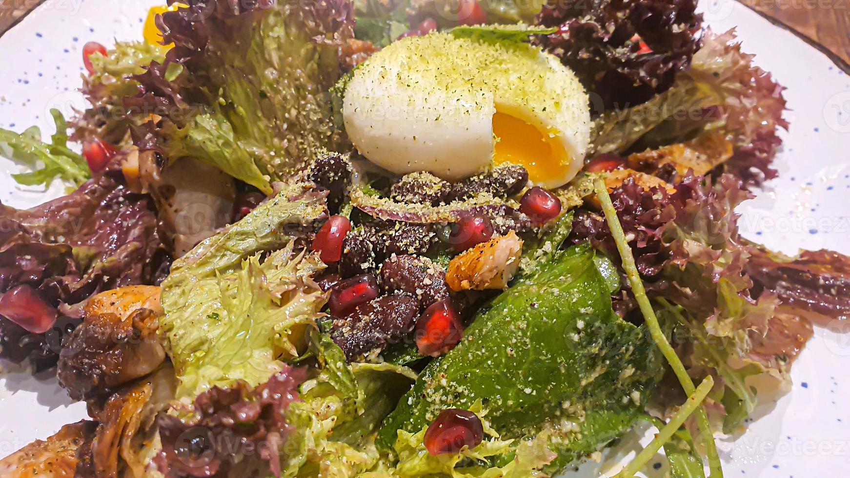 Diet salad of fresh vegetables. Lettuce, poached egg, tomatoes, green onions and chili peppers. Sauce. photo